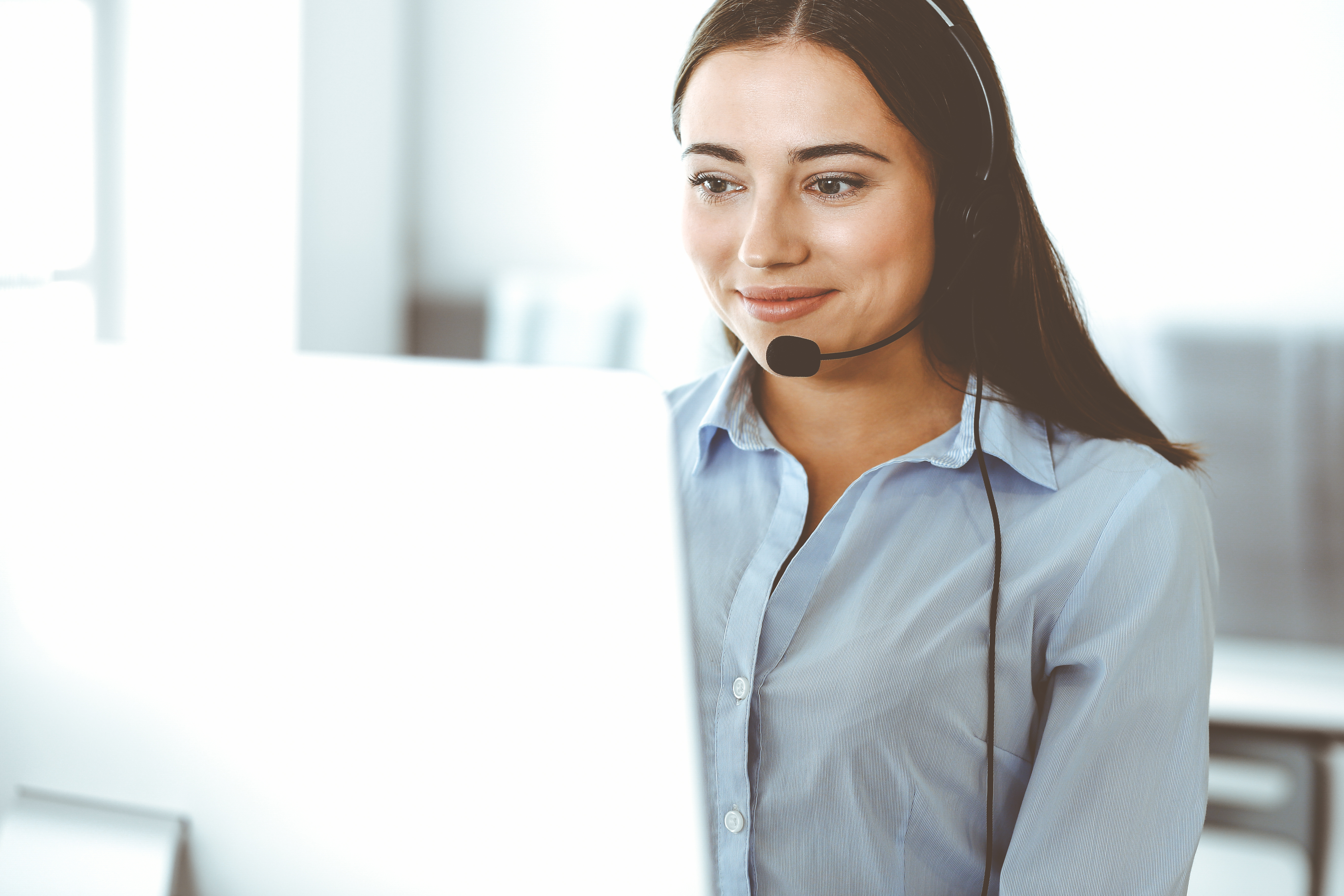 Woman at laptop with headset